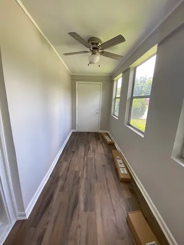 wooden floor in an empty room with a window