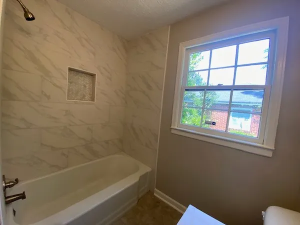 a bath tub sitting next to a blue sink and a toilet
