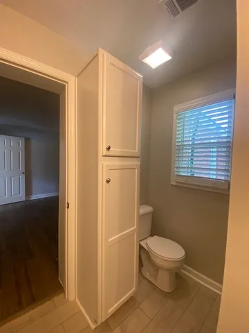 a white toilet sitting next to a bathroom sink