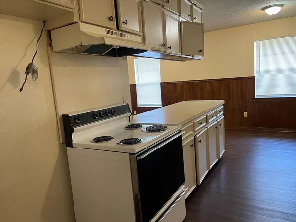 a kitchen with a stove and a microwave