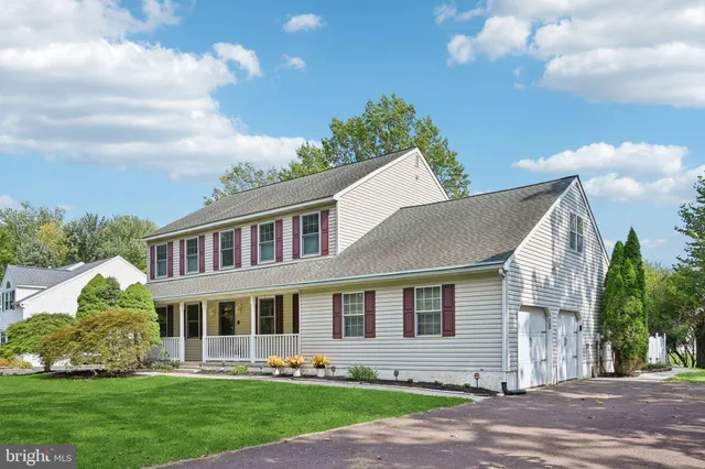 a front view of a house with a garden and plants
