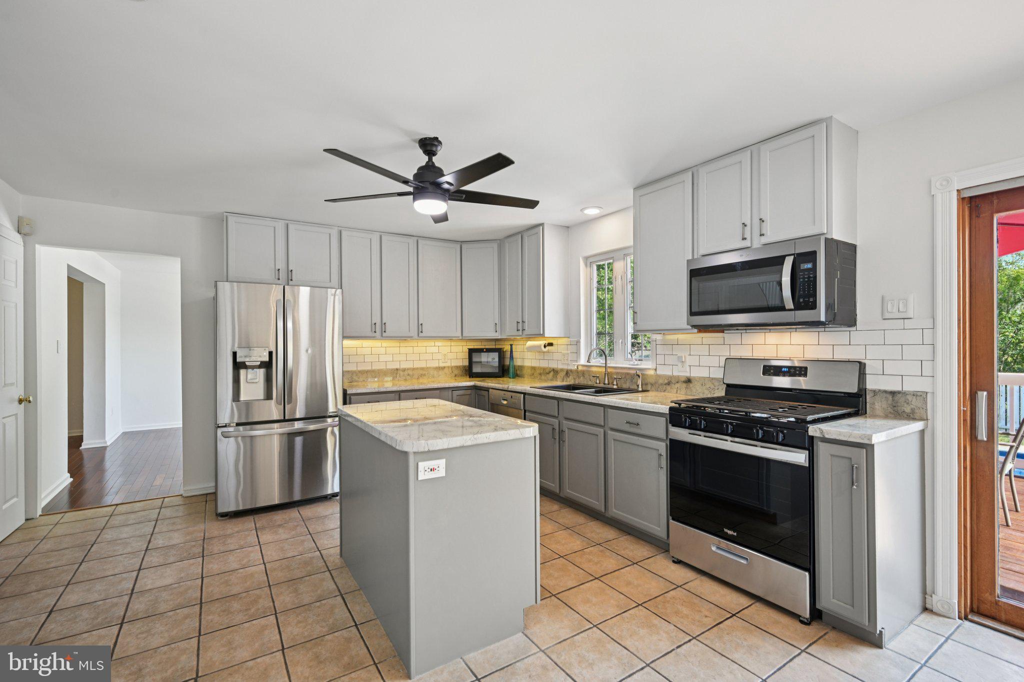 821 West Orvilla Road Hatfield, PA 19440 - Photo 17 of 64 a kitchen with stainless steel appliances granite countertop a stove sink and refrigerator