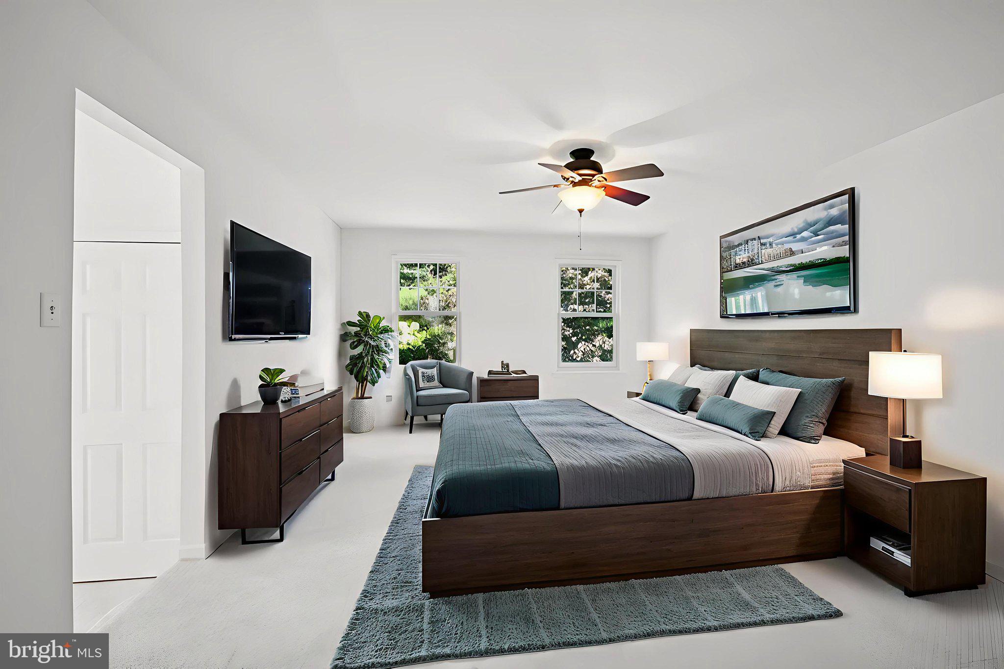 821 West Orvilla Road Hatfield, PA 19440 - Photo 27 of 64 a bedroom with a bed a couch and a flat screen tv