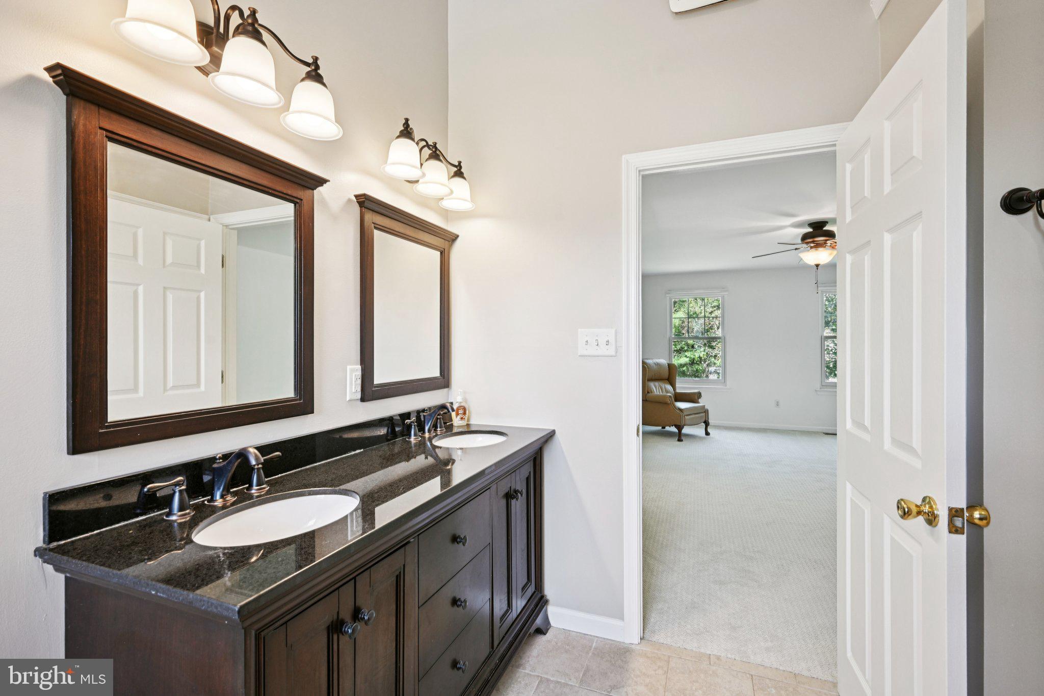 821 West Orvilla Road Hatfield, PA 19440 - Photo 29 of 64 a bathroom with a sink double vanity granite and a mirror
