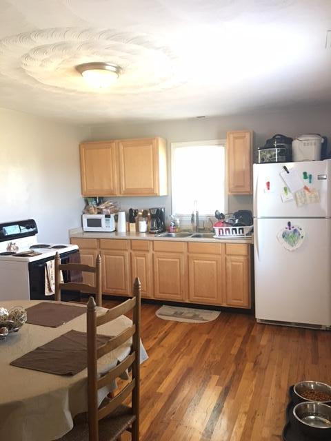 1756 Goodview Road Goodview, VA 24095 - Photo 8 of 10 a kitchen with kitchen island a stove a sink and a refrigerator