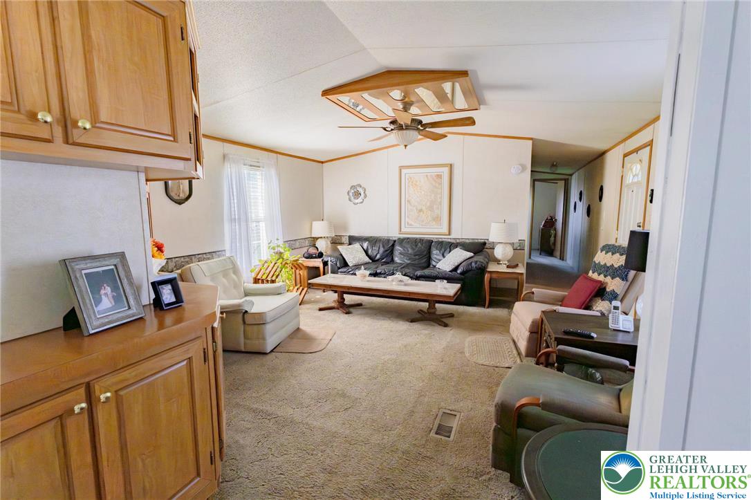 554 Norman Road Nazareth, PA 18064 - Photo 11 of 20 a living room with furniture and a chandelier