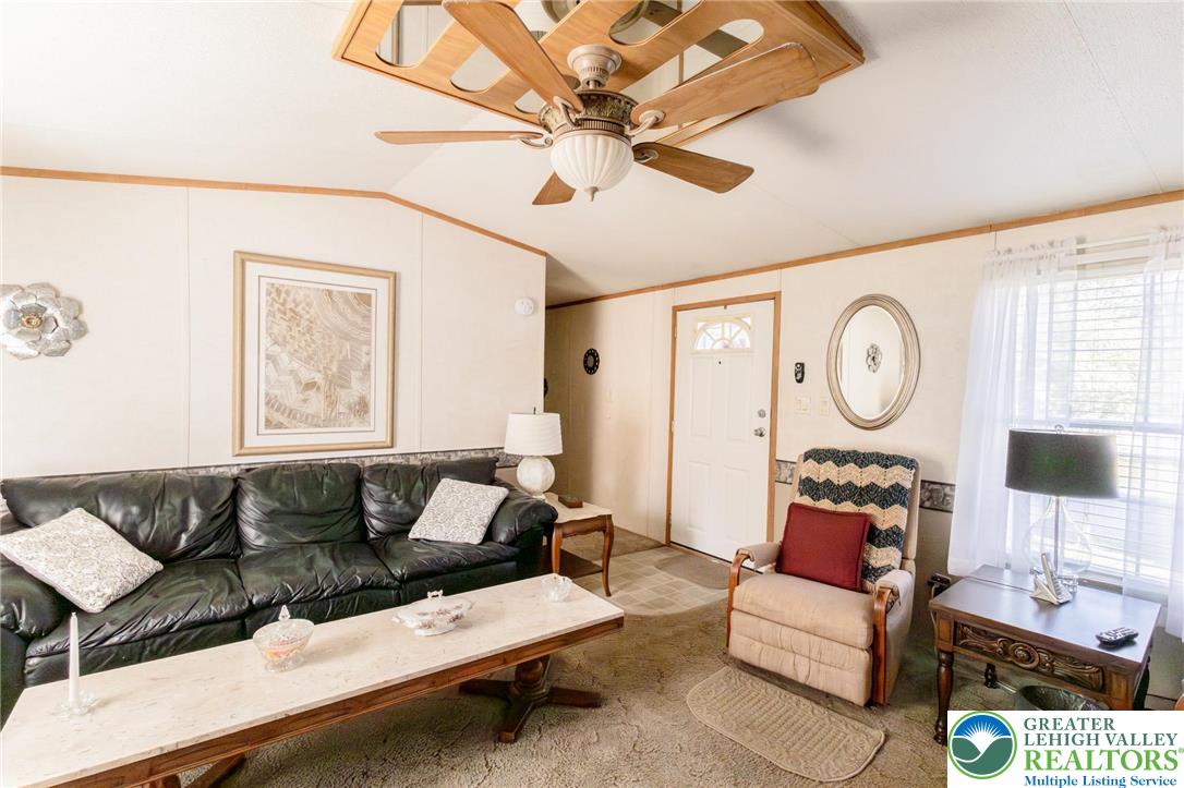 554 Norman Road Nazareth, PA 18064 - Photo 13 of 20 a living room with furniture a clock on wall and a window