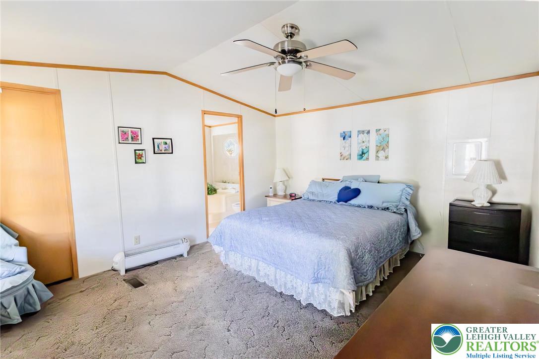 554 Norman Road Nazareth, PA 18064 - Photo 20 of 20 a spacious bedroom with a bed and a chandelier