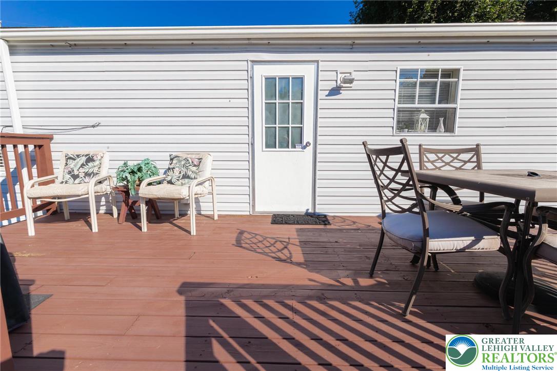 554 Norman Road Nazareth, PA 18064 - Photo 4 of 20 a view of a patio with table and chairs with wooden floor and fence