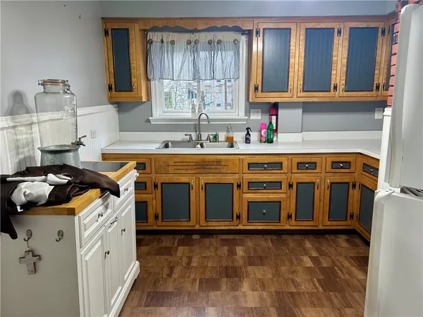 a view of a kitchen with stainless steel appliances granite countertop a stove and a sink