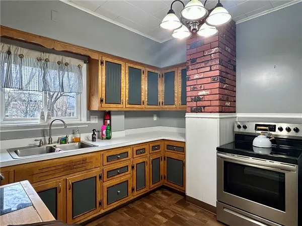 a kitchen with a stove window and cabinets