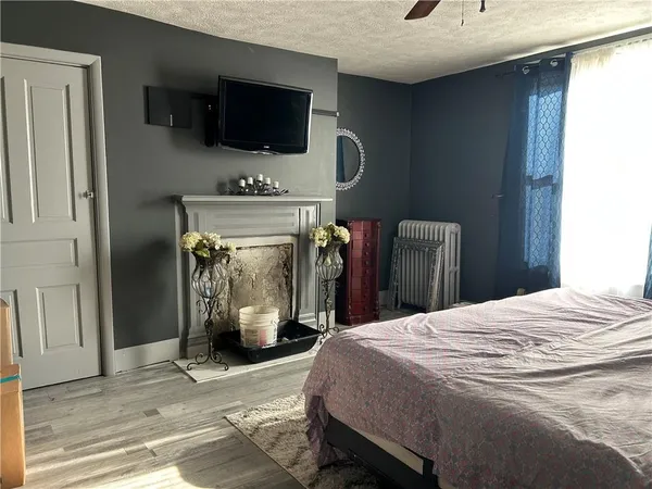 a bedroom with a bed and a television