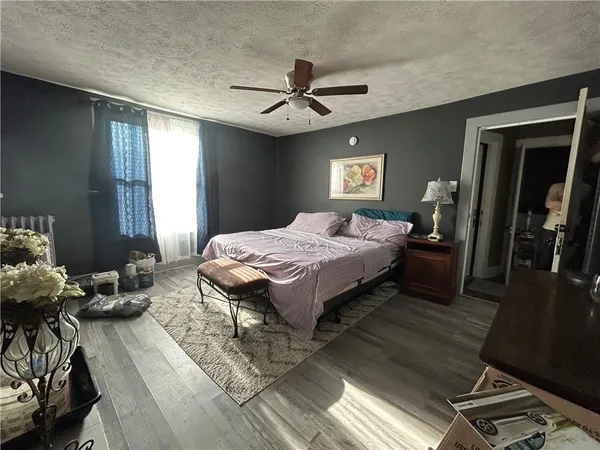 a bedroom with a bed and a chandelier
