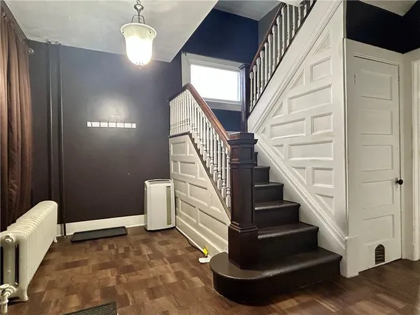 a view of entryway and hall with wooden floor