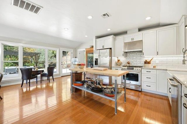a view of a livingroom with furniture hardwood floor and a living room