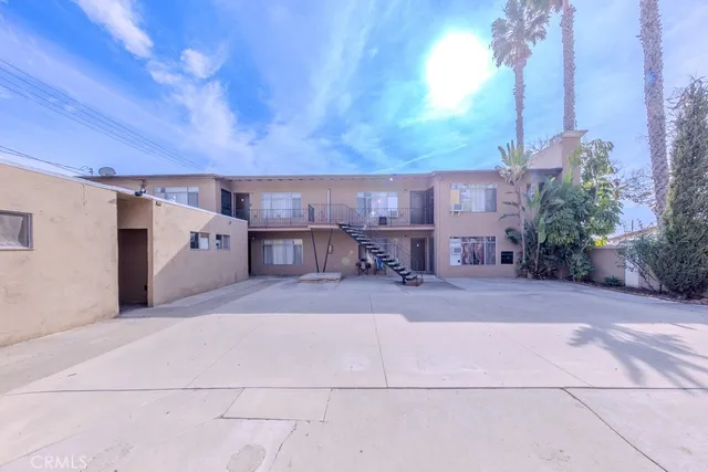 a view of a patio with a table and chairs and potted plants