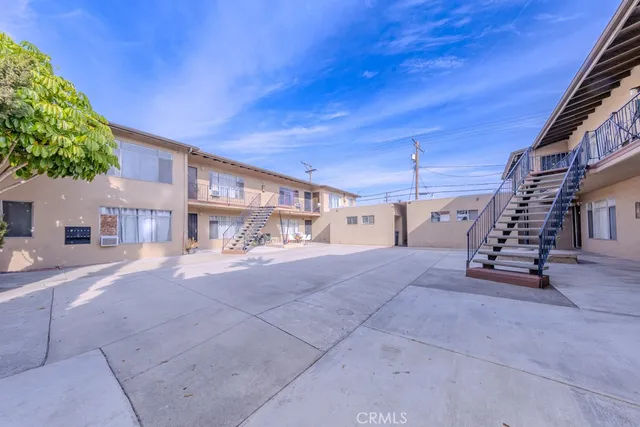 a view of a street with potted plants