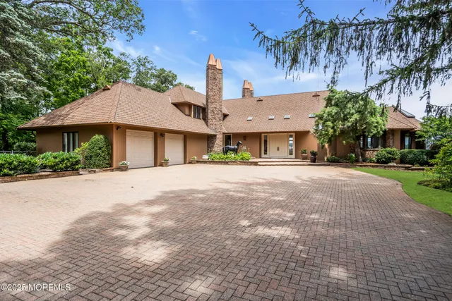 a living room with furniture kitchen view and a large window