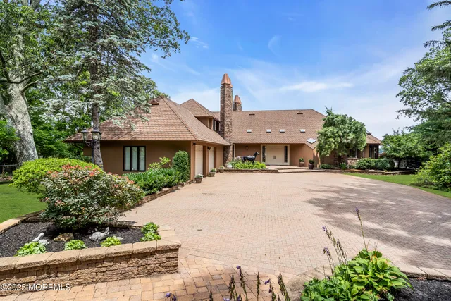 a kitchen with stainless steel appliances kitchen island granite countertop a table and chairs in it