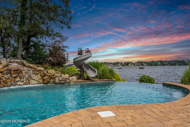 a view of a lake with houses in the back
