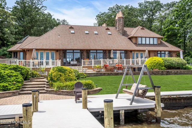 a living room with furniture and large windows
