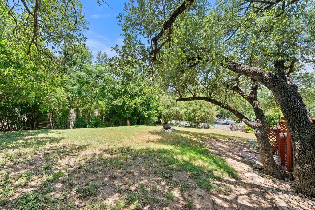 5208 Sioux Lane Austin, TX 78734 - Photo 33 of 35 Mature trees and verdant foliage frame a spacious, private yard.