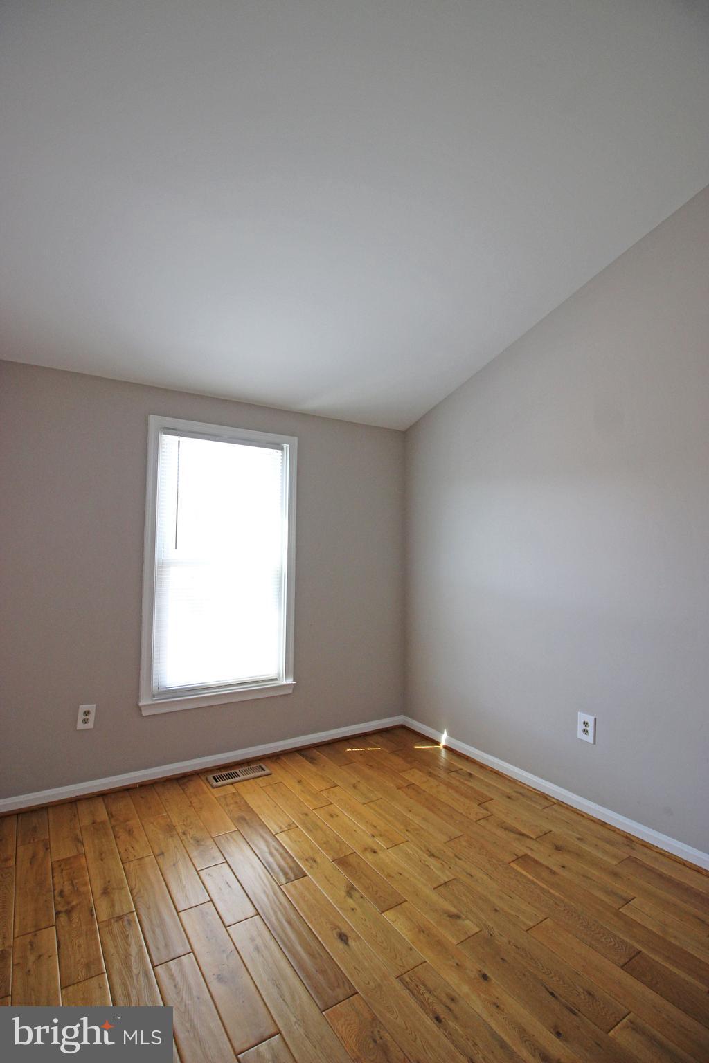7609 Monitor Court Manassas, VA 20109 - Photo 17 of 32 an empty room with wooden floor and windows