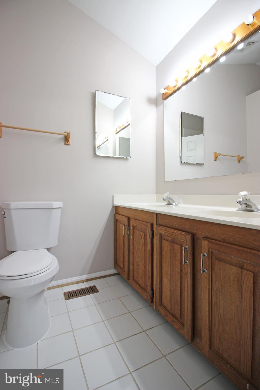 7609 Monitor Court Manassas, VA 20109 - Photo 25 of 32 a bathroom with a sink a toilet and mirror