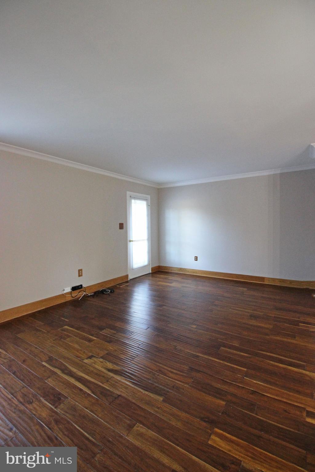 7609 Monitor Court Manassas, VA 20109 - Photo 7 of 32 an empty room with wooden floor and windows