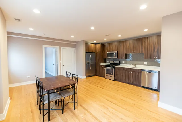 a kitchen with a table and chairs in it
