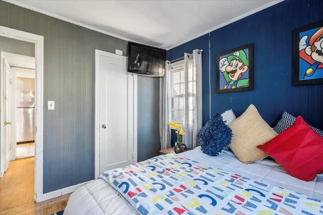 a spacious bedroom with a bed and a window