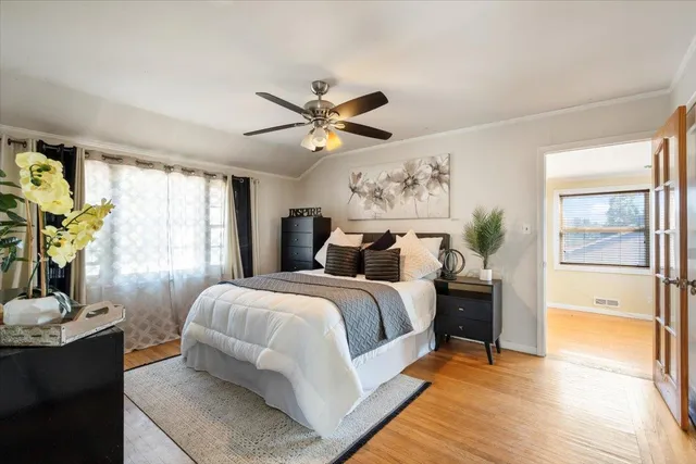 a bedroom with a bed and a chandelier