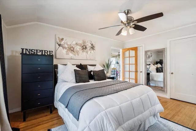 a view of hallway with stairs and wooden floor