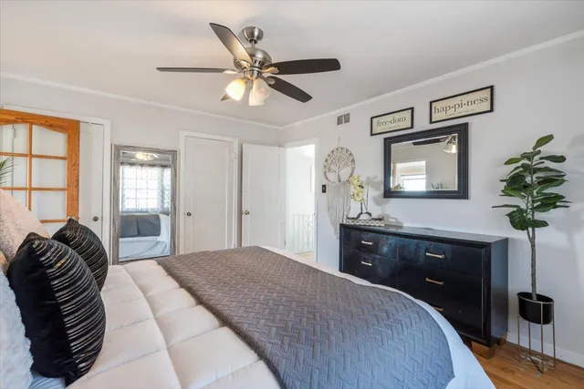 a view of a hallway with wooden floor and a chandelier