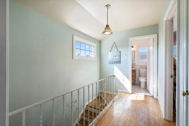 a bathroom with a toilet sink and a mirror