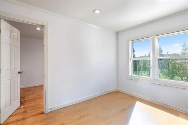 a view of an empty room with stairs and ventilation