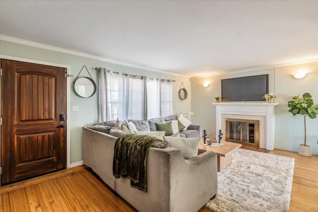 a living room with furniture a fireplace and a flat screen tv