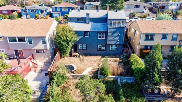 a backyard with garden area and outdoor seating