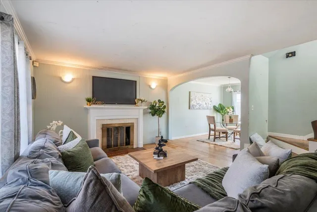 a living room with furniture a fireplace and a flat screen tv