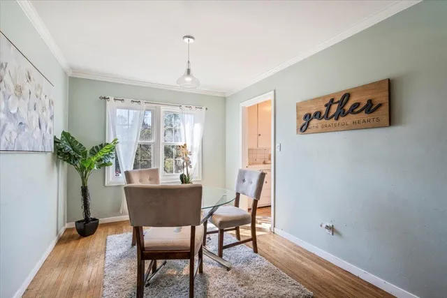 a view of a dining room with furniture window and wooden floor