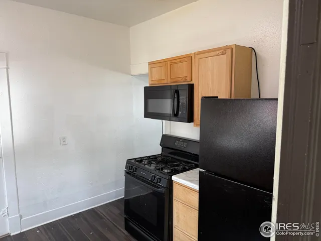 a kitchen with a refrigerator and a stove