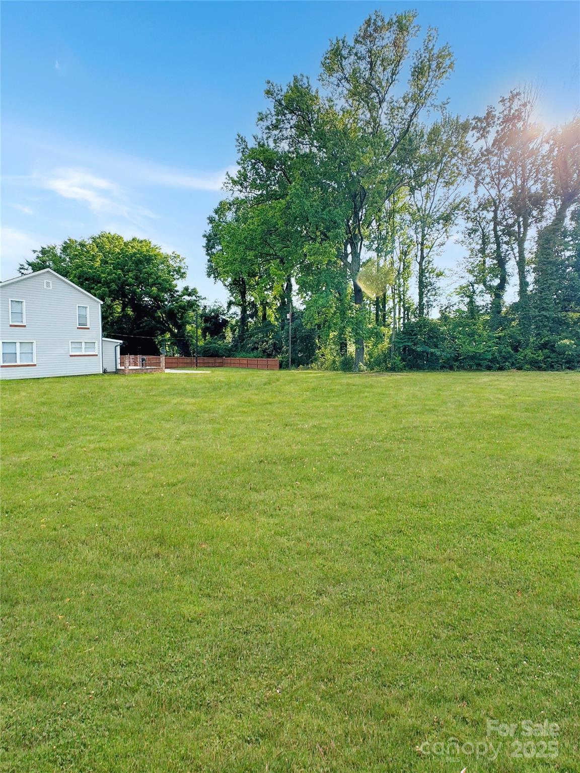 a view of field with trees in the background
