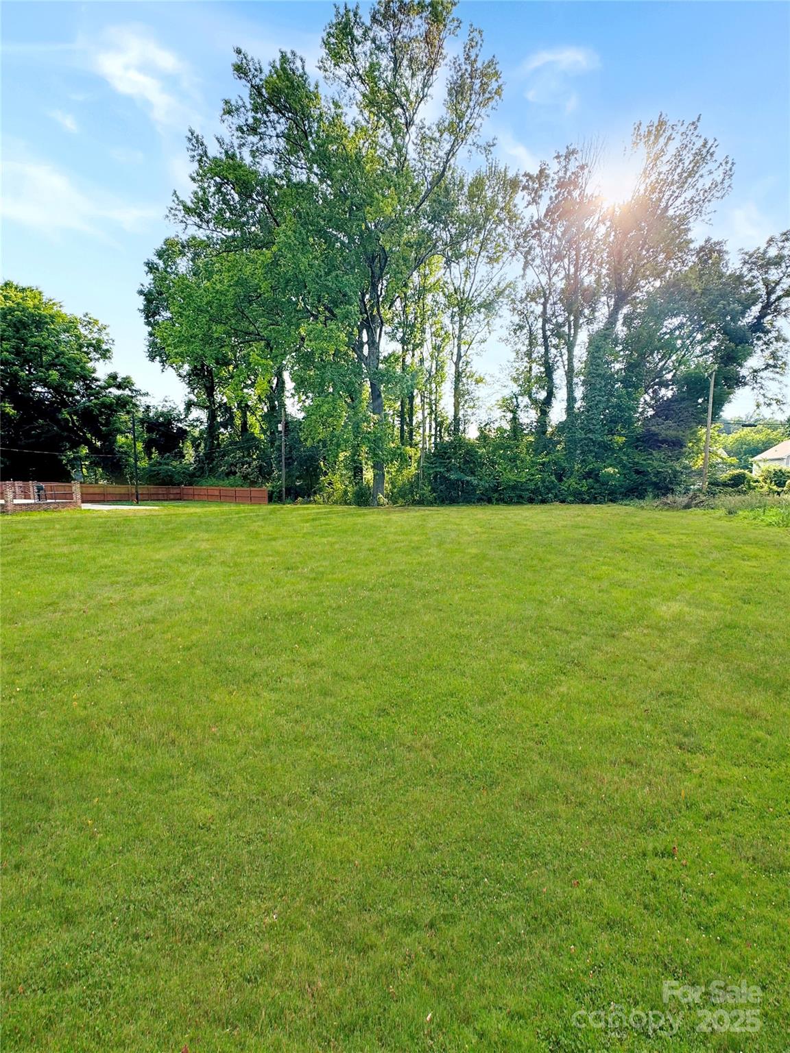 1717 Beatties Ford Road Charlotte, NC 28216 - Photo 2 of 6 a view of a green field with trees in the background