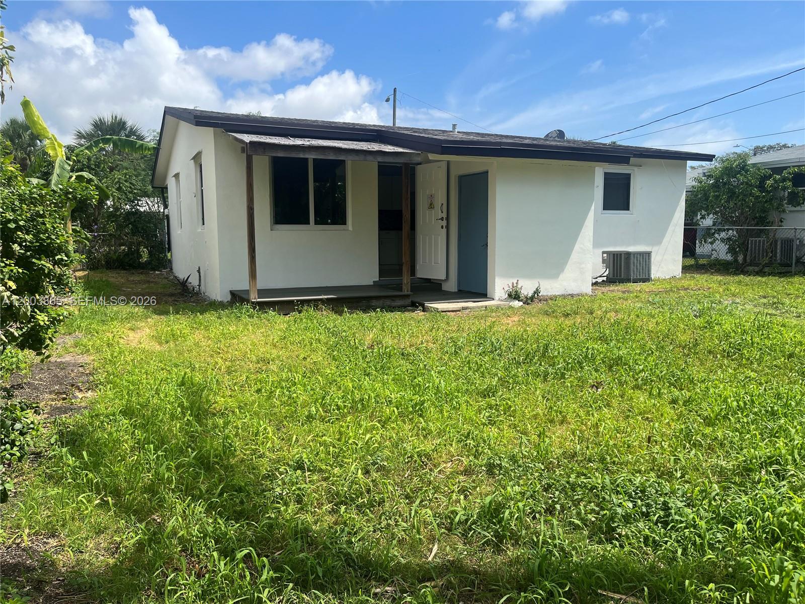 753 Southwest 3rd Street Dania Beach, FL 33004 - Photo 11 of 16 a house with a yard