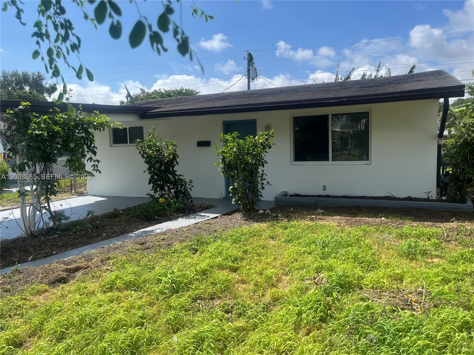 753 Southwest 3rd Street Dania Beach, FL 33004 - Photo 15 of 16 a front view of house with yard