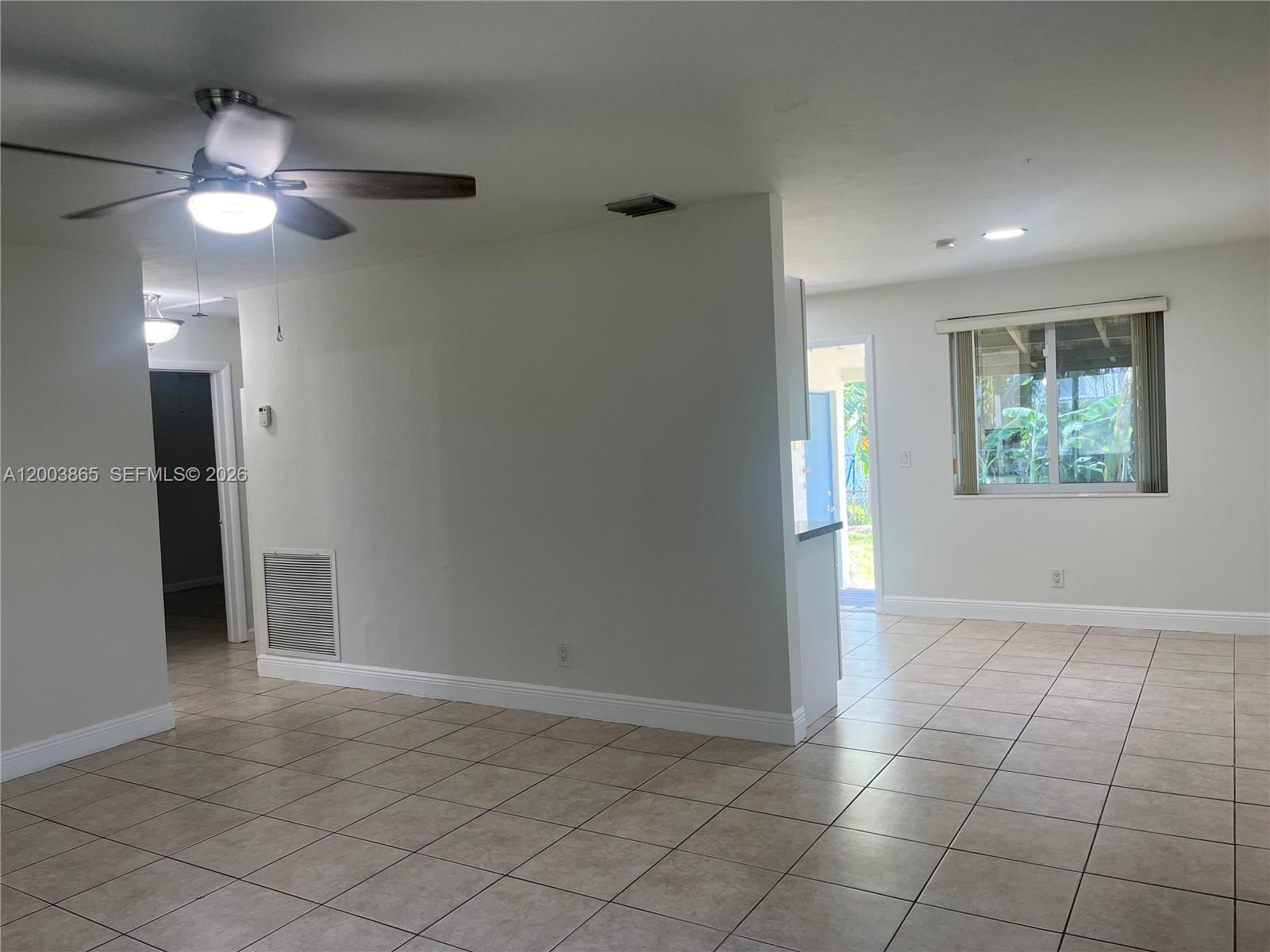 753 Southwest 3rd Street Dania Beach, FL 33004 - Photo 3 of 16 a view of an empty room with window and chandelier fan