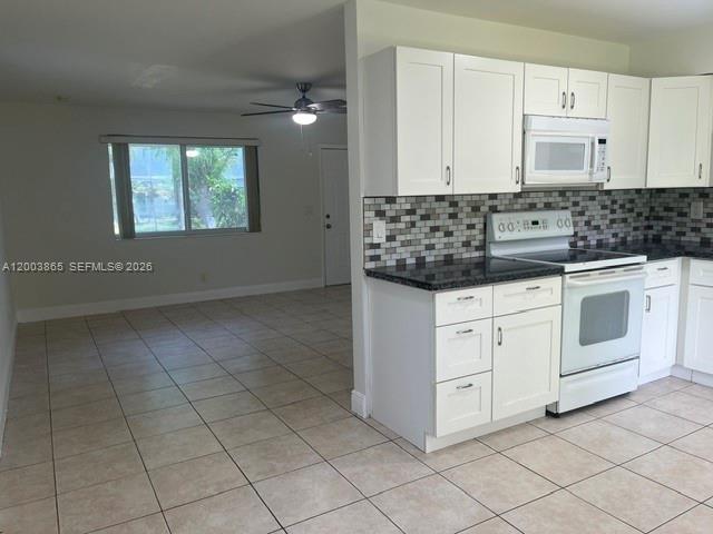 753 Southwest 3rd Street Dania Beach, FL 33004 - Photo 5 of 16 a kitchen with granite countertop white cabinets and white appliances