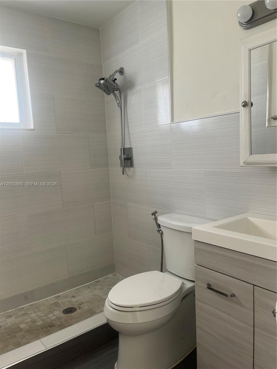 753 Southwest 3rd Street Dania Beach, FL 33004 - Photo 6 of 16 a bathroom with a sink a toilet and shower