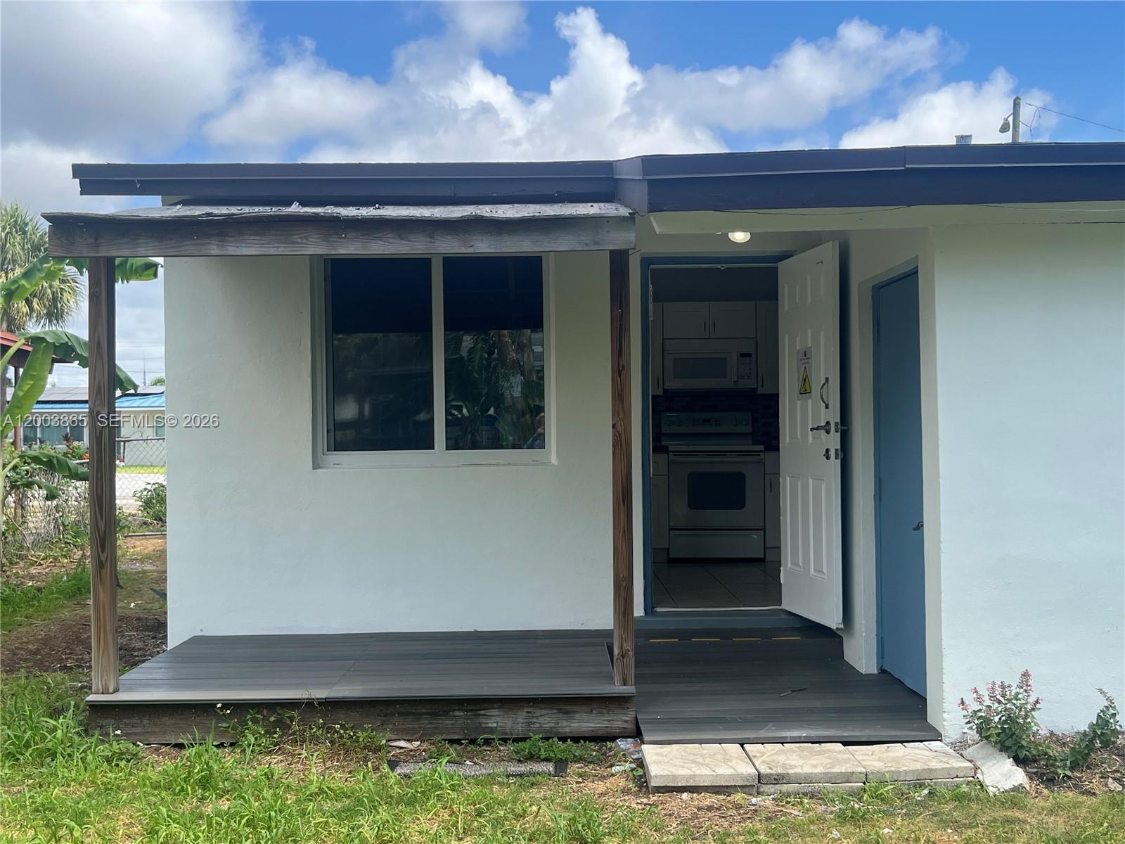 753 Southwest 3rd Street Dania Beach, FL 33004 - Photo 10 of 16 a front view of a house with a yard