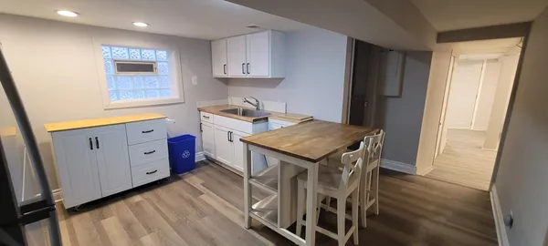 a kitchen that has a microwave a sink and a stove in it